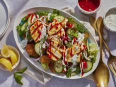 This Grilled Halloumi and Potato Salad takes &ldquo;grilled cheese&rdquo; literally in this Berlin d&ouml;ner-inspired dish, drizzled with zesty sauces, herbs and fresh veggies.