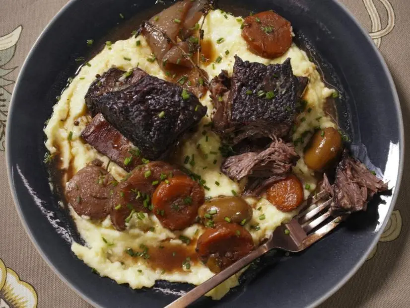 Geoffrey Zakarian's Braised Short Ribs with Smoked Olives Beauty, as seen on The Kitchen, Season 36.