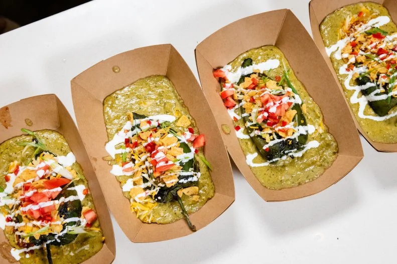 Host Selena Gomez and Moo's Craft Stuffed walking taco chile relleno, as seen on Selena + Chef: Home for the Holidays, Season 5.