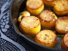 Using Yukon golds with duck fat gives a deep flavor and golden finish. The scallop-like presentation and final touch of butter broth and sea salt make this dish both delicious and visually appealing. Cooking them on the grill or even using some smoked sea salt will impart a subtle smoky flavor.