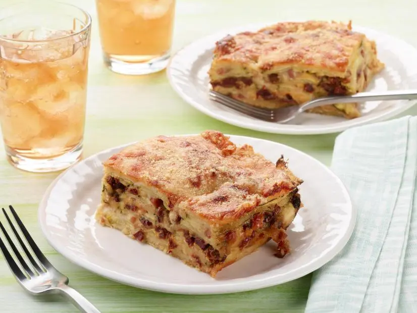 Food Network Kitchen’s Cheesy Zucchini Bake with Pancetta and Sun-Dried Tomatoes as seen on Food Network.