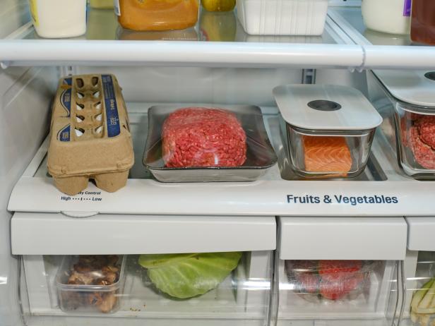 The inside of a refrigerator, with food stored in separate containers for safety.