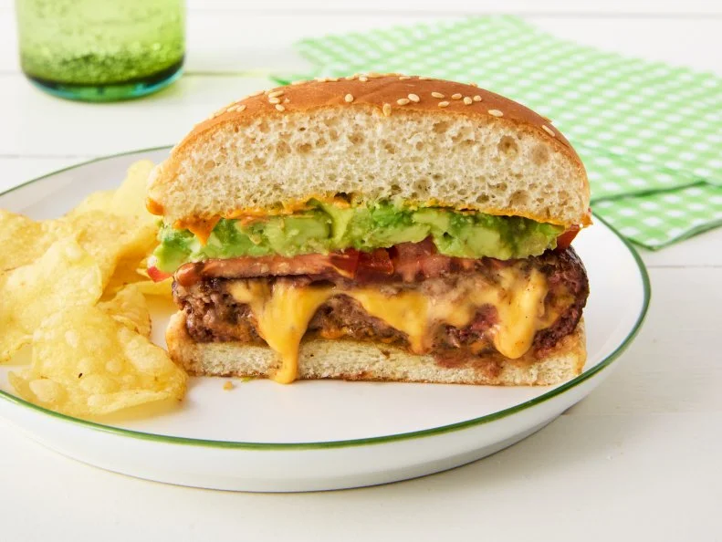 QUESO-STUFFED BURGERS. Stuffed burger\, hamburger. Cheeseburger stuffed with Velveeta cheese. American cheese. Avocado\, guacamole.
