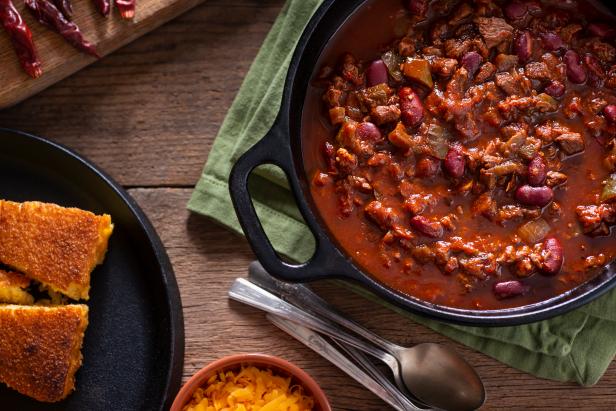 Classic Southwestern Chili in a Cast Iron Dutch Oven with Corn Bread and Cheddar Cheese