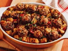 This is the stuffing for mushroom lovers. All the savory flavors of stuffed mushrooms are incorporated into the cubed-bread casserole itself, including sausage, diced bell pepper, scallions, parsley and thyme. Then the top gets covered with individual stuffed mushroom caps for an irresistible presentation that&rsquo;s bound to wow. Plenty of broth and butter keep the stuffing juicy and moist, while a topping of panko and Parmesan gets wonderfully browned and crispy for a classic stuffing contrast.
