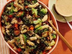 This veggie-forward pasta salad has everything you would expect in a Thanksgiving meal, except the turkey! We took tender rotini and added plenty of seasonal roasted vegetables like Brussels sprouts, sweet potatoes and kale. Sweet-tart cranberries and crunchy pistachios are laced throughout for texture and brightness, then it&rsquo;s tossed with a nutty tahini dressing with fresh sage, thyme and a hint of maple syrup. The result is a vegetarian dish that&rsquo;s bound to please everyone at the table, and one that can be vegan if you ensure your Dijon and pasta are vegan-friendly.