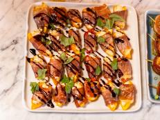 Ree usually makes her poppers using jalape&ntilde;os and wraps them in bacon. To switch things up a little, she&rsquo;s using sweet peppers and wrapping them in prosciutto. Stuffed with herbed goat cheese, each popper makes one delicious mouthful.
