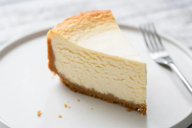 New York Cheesecake Slice On Plate. Closeup view. Tasty smooth cheesecake