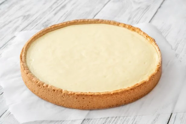 Traditional cheesecake on the wooden table closeup
