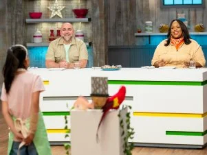 Hosts Duff Goldman and Kardea Brown taste Contestant Arielle Yang's tart, Chameleon and Scales TAIL TWIST: Peanut Butter Cookie Tail MENU: Chameleon Tart with Lime Pastry Cream and Swiss Meringue Buttercream Scales, as seen on Kids Baking Championship, Season 13.