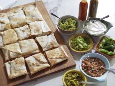 Talk about a crowd pleaser. These quesadillas can feed the entire crew and all you have to do is cut them and set up a toppings bar. This is more about the technique than anything, so think about rotisserie chicken or even full-on veggies inside with the cheese. Make it your own!