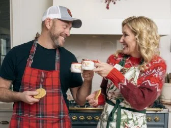 Hosts Dave and Jenny Marrs pose in their kitchen, as seen on Fixer to Fabulous Holiday Social Project on HGTV.