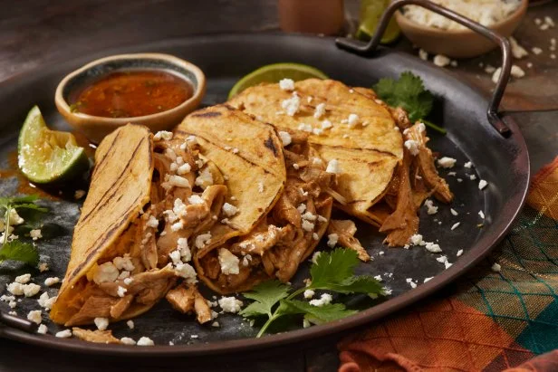 Braised Chicken Birria Tacos in Corn Tortillas with Cilantro and Cotija Cheese