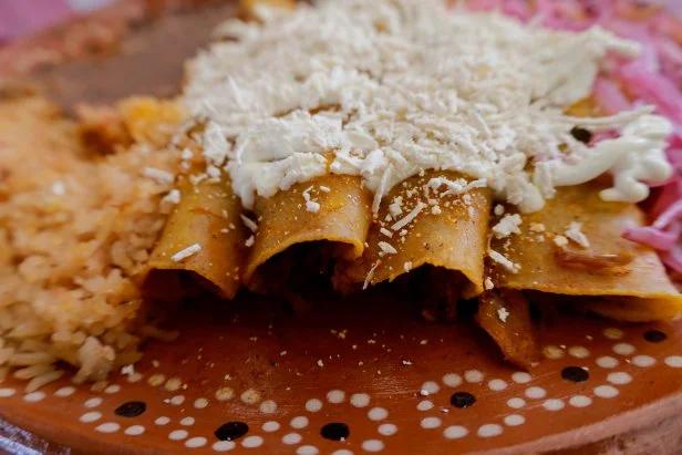 View of a plate of enchiladas on the occasion of the Enchilada Fair on the esplanade of the Iztapalapa mayor's office in Mexico City, which brought together around 39 exhibitors from different neighborhoods to offer a wide variety of the preparation of enchiladas - a typical dish Mexican based on tortilla, spicy or non-spicy sauce and stew - as part of the support programs for the local economy of said district.According to the National Institute of Anthropology and History, this dish has its origins in pre-Columbian civilizations, even present in the Florentine Codex that mentions the word chillapitzalli, which is made up of the Nahuatl word chilli, which means chili, and tlapitzalli. which means flute, that is, flauta enchilada, described in the same text as a corn tortilla and chili dish. (Photo by Gerardo Vieyra/NurPhoto via Getty Images)