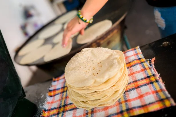 MORELIA, MEXICO - NOVEMBER 5: A pile of freshly made tortillas is seen placed on a cloth in a tortillerÃ­a on November 5, 2022 in Morelia, Mexico. Tortillas are an essential element in the Mexican cuisine and has been part of the culture in Mesoamerica since thousand of years. (Photo by Jan Sochor/Getty Images)