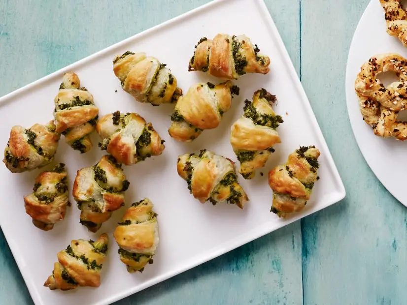 Appetizers: Chorizo Pigs in a Blanket (top left)\, Everything Pretzels (bottom\, middle)\, Herb Rolls (left).