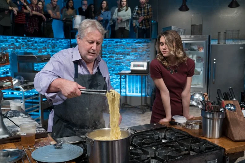 Co-host Sophie Flay checks in with challenger Jonathan Waxman, as seen on Food Network's Beat Bobby Flay, Season 13.