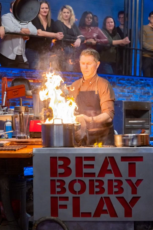 Host Bobby Flay prepares signature dish,  as seen on Beat Bobby Flay, Season 40