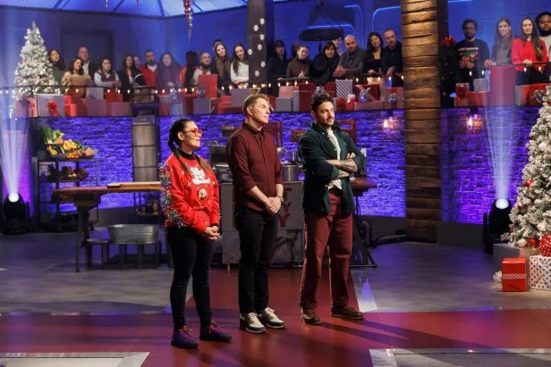 Contender Claudette Zepeda, Chef Bobby Flay, and contender Gabriele Bertaccini await the results of Round 1, as seen on Beat Bobby Flay Holiday Throwdown, Season 4.