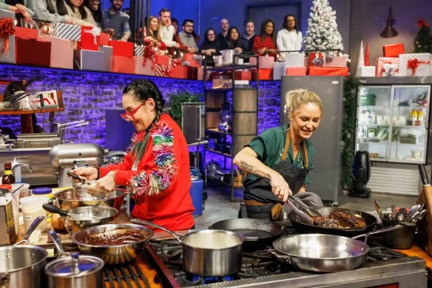 Contenders Brooke Williamson and Claudette Zepeda work on their Round 3 dishes, as seen on Beat Bobby Flay Holiday Throwdown, Season 4.