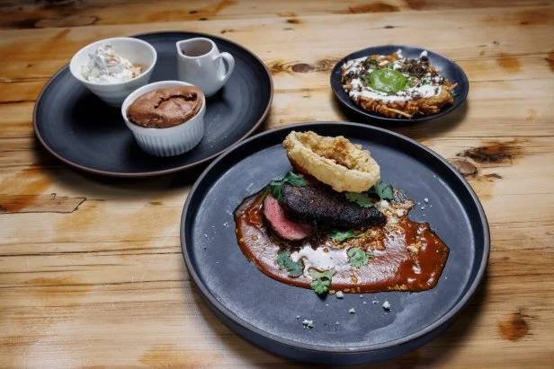 Chef Bobby Flay and contender Gabriele Bertaccini's Chateaubriand with Smoked Chile Sauce and Onion Rings, Latkes with Black Truffle, and Chocolate Soufflé with Cinnamon and Chiles, as seen on Beat Bobby Flay Holiday Throwdown, Season 4.