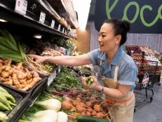 Contestant Shirley Chung selects some ingredients from the produce section, as seen on Guy's Grocery Games, season 32.