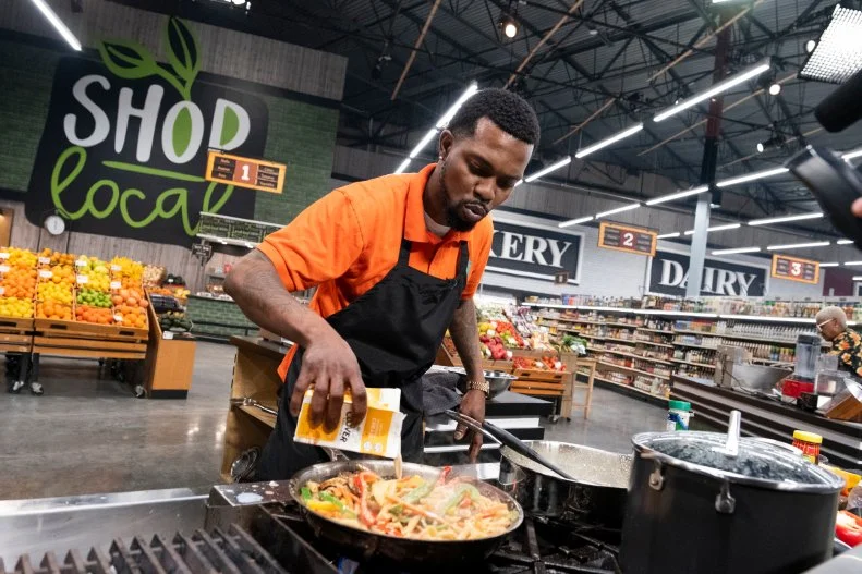 Contestant Oniel Smith adds cream to vegetables