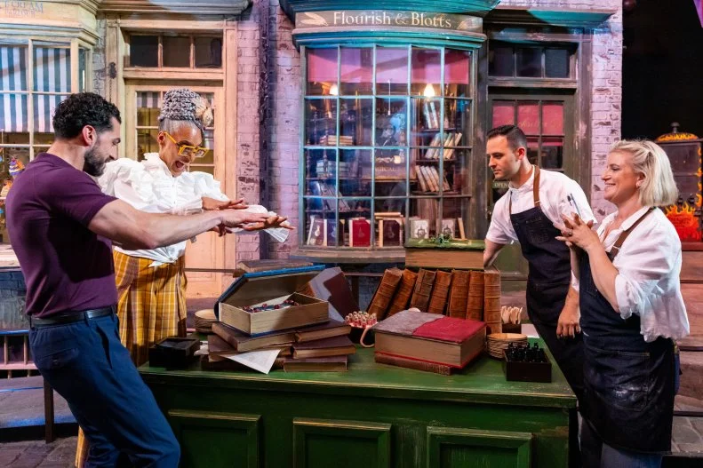 Judges Jozef Youssef and Carla Hall with Contestants Jordan Pilarski and Zoe Burmester during the judging in Diagon Alley, as seen on Harry Potter: Wizards of Baking, Season 1.