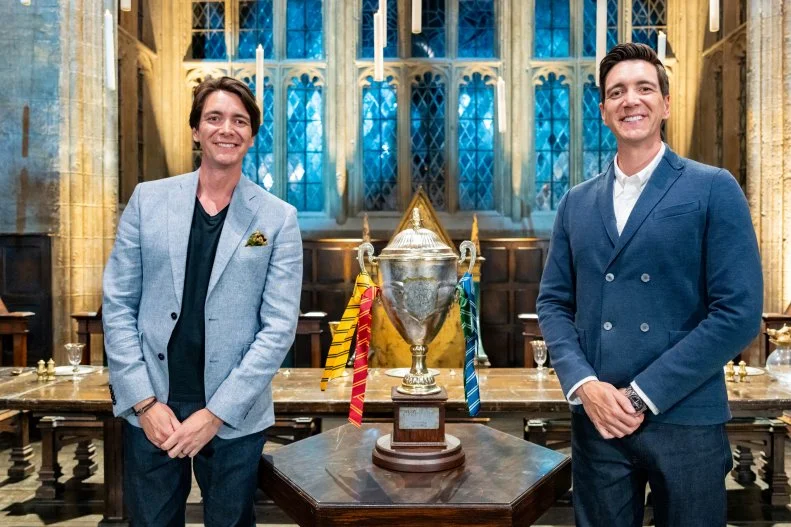 Hosts James and Oliver Phelps with the Winners Cup in The Great Hall, as seen on Harry Potter: Wizards of Baking, Season 1.