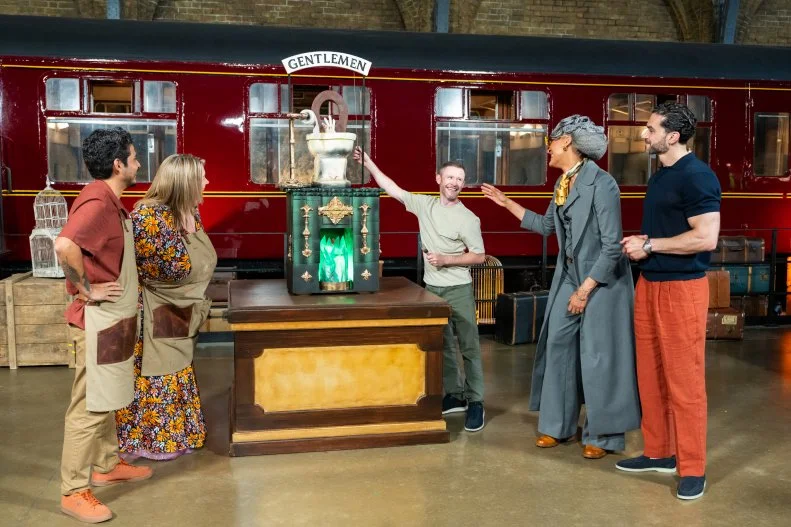 Judge Carla Hall and Judge Jozef Youssef and special guest judge Devon Murray with contestants Jenny Chambers and Alex Madrigal’s showpiece titled ‘Whitehall Underground Public Toilets’, as seen on Harry Potter: Wizards of Baking, Season 2.