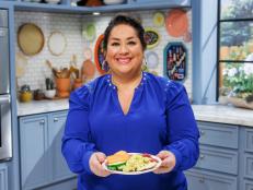 Ayesha Nurdjaja poses with Tunisian Egg Salad, as seen on The Kitchen, Season 39/40