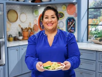 Ayesha Nurdjaja poses with Tunisian Egg Salad, as seen on The Kitchen, Season 39/40