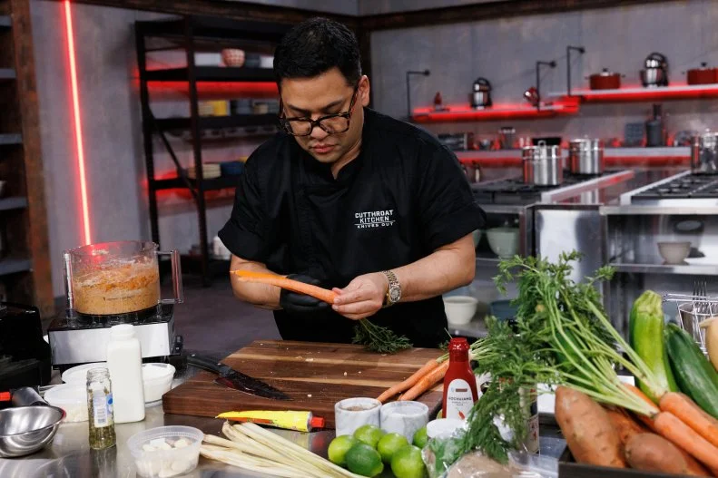 Chef Arnold Myint is forced to us carrots as skewers instead of metal skewers to make kebabs after being sabotaged during round two, as seen on Cutthroat Kitchen: Knives Out, Season 1.