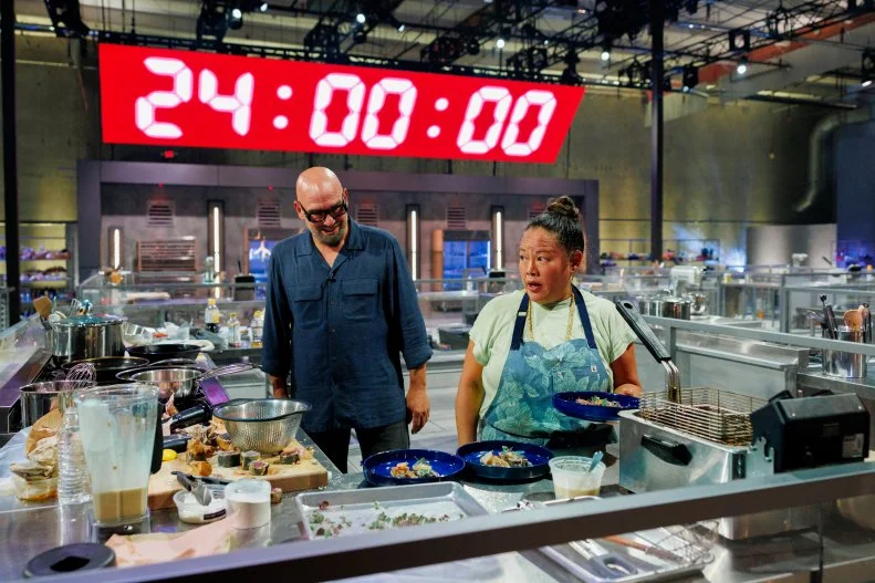 Host Michael Symon congratulates Contestant Lee Anne Wong on the final round, as seen on 24 in 24: Last Chef Standing, Season 3.