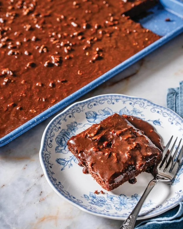 Ree Drummond's chocolate sheet cake in a pan and on a plate.