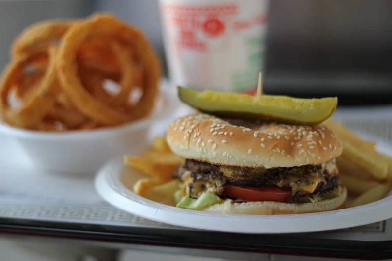 Closeup of the Jumbo Cheeseburger and onion rings at South 21 Drive-In, Charlotte, NC, as seen on Travel Channel's Burger Land.