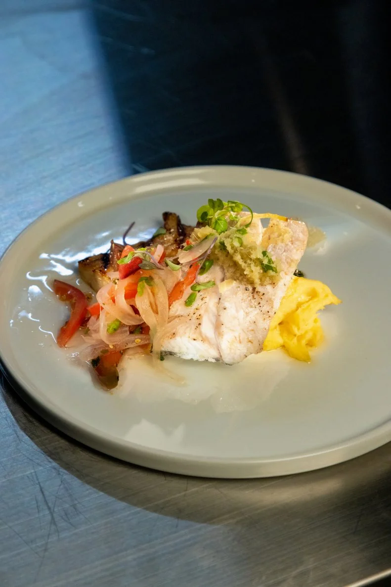 Contestant Ippy Aiona's round 1 dish, Cilantro, ginger , sake and soy steamed kanpachi with chinese ginger sauce, teriyaki glazed alii mushroom, heirloom tomato pickled sweet onion “lomi” salad, coconut, Hawaiian salt curried ulu mash, as seen on Alex vs America, Season 3.