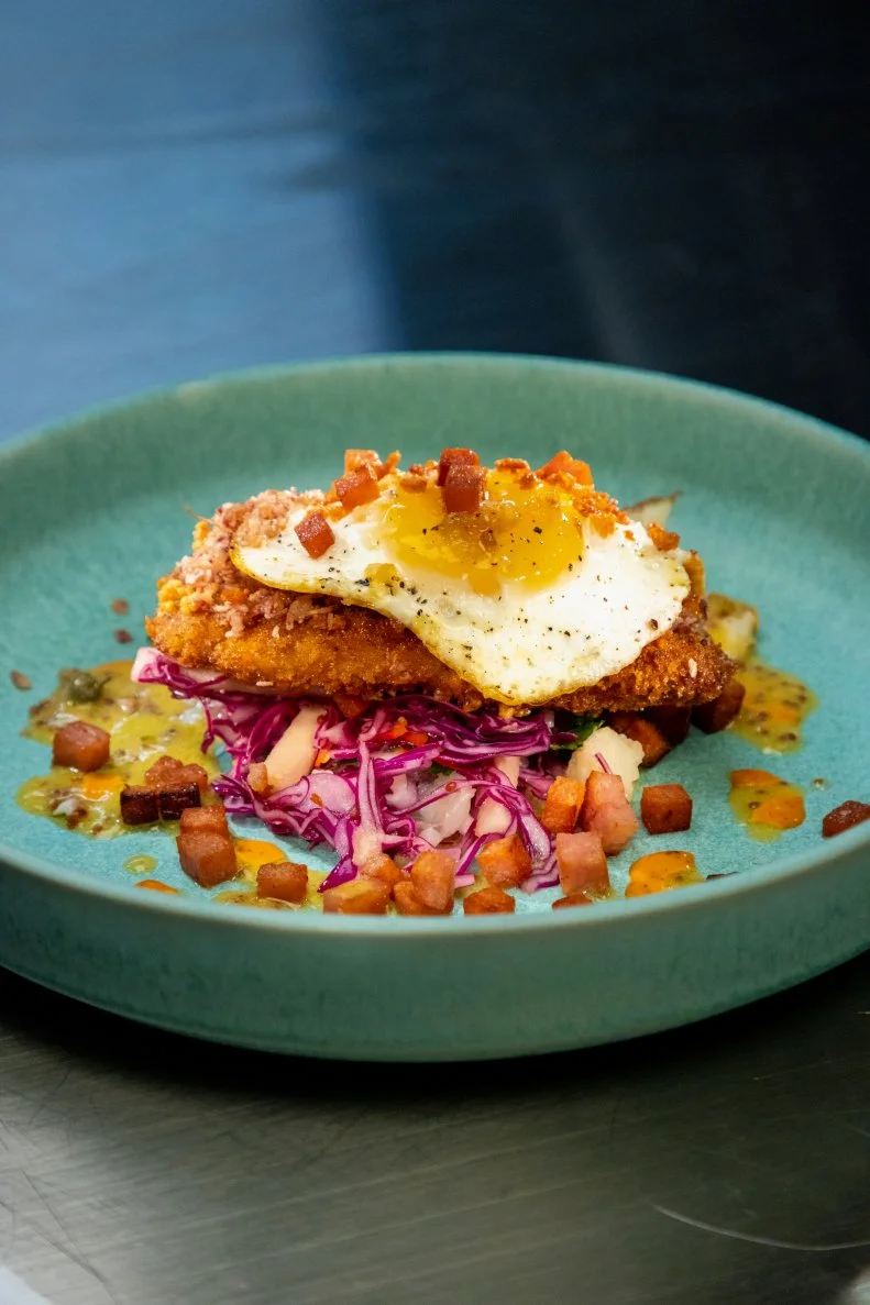 Alex Guarnaschelli's round 2 dish, Pork schnitzel with crispy taro and gochujang mayo, cabbage, apple, cilantro, and mustard slaw, fried egg with crispy Hawaiian steak bits, as seen on Alex vs America, Season 3.