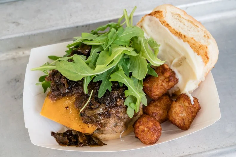 Brunch Babes menu item, The Babes Burger - Maple Beef & Pork Patty, Sharp Cheddar, arugula, bacon-onion jam, maple mayo on a buttered bun, as seen on The Great Food Truck Race, Season 10.