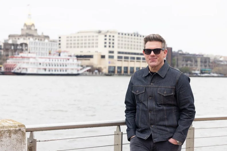 Host Tyler Florence poses along the river in Savannah, Georgia, as seen on The Great Food Truck Race, Season 18.