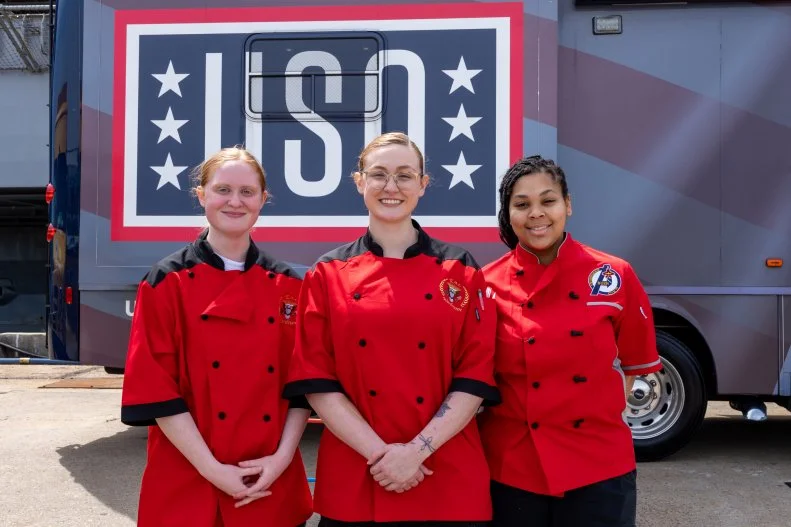 Navy chefs posing aboard the USS George H.W. Bush 