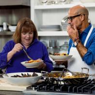 Ina Garten cooking fish stew with Stanley Tucci, as seen on Be My Guest with Ina Garten, season 3.