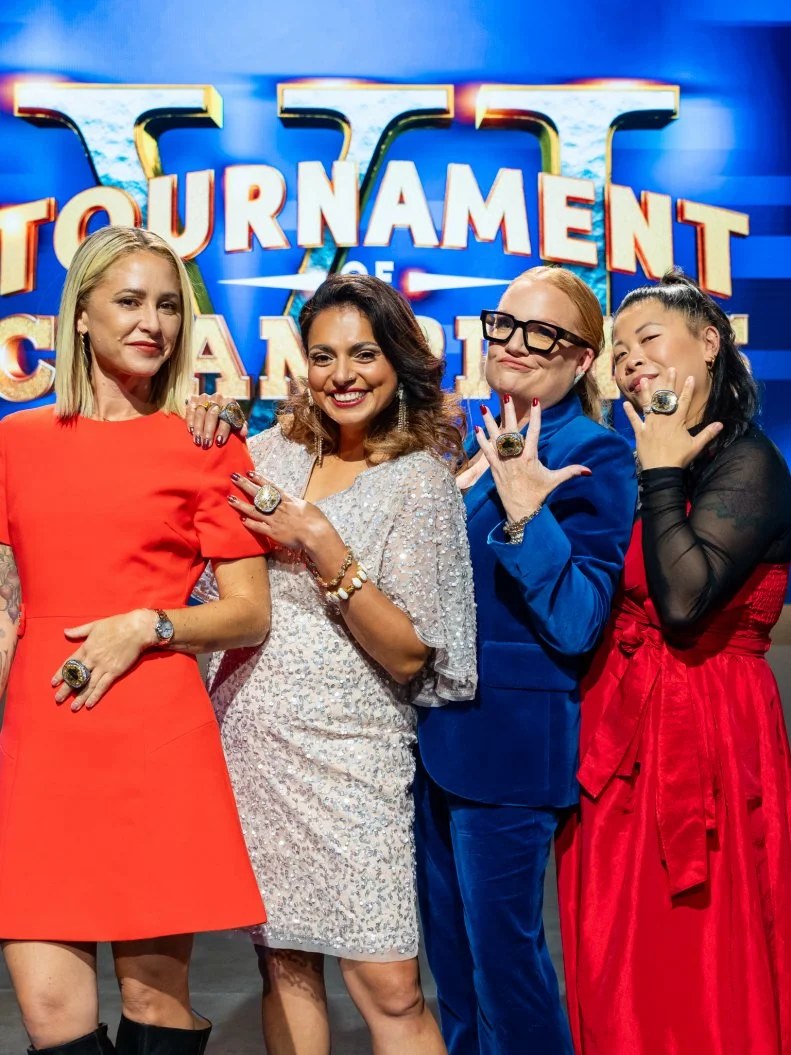 Former Tournament of Champions show off their Championship rings, judge Brooke Williamson, judge Maneet Chauhan, Floor Commentator Tiffani Faison, and judge Mei Lin, as seen on Tournament of Champions, Season 6.