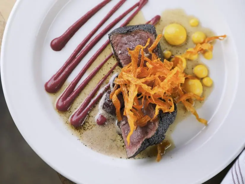 Coffee Dusted Seared Venison as prepared by Chef/Owner Terry Koval at The Deer and The Dove in Atlanta, Georgia, as seen on Food Network's Diners Drive-Ins and Dives, season 41.