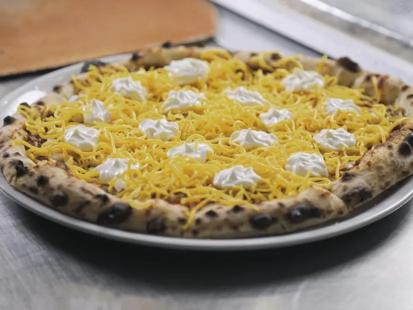 Cincinnati Chili Pizza as prepared by Chef/Owner Eric Redfield at Camporosso in Cincinnati, Ohio, as seen on Food Network's Diners Drive-Ins and Dives, season 42.