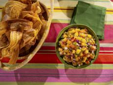 Plantain chips and mango salsa always remind me of a Caribbean vacation. I brought the vibes home and added some peach and a spin on the plain plantain chips I've been served that makes them craveable even without the salsa. If you can't make planks, slicing rounds or ovals on the bias are just as tasty.