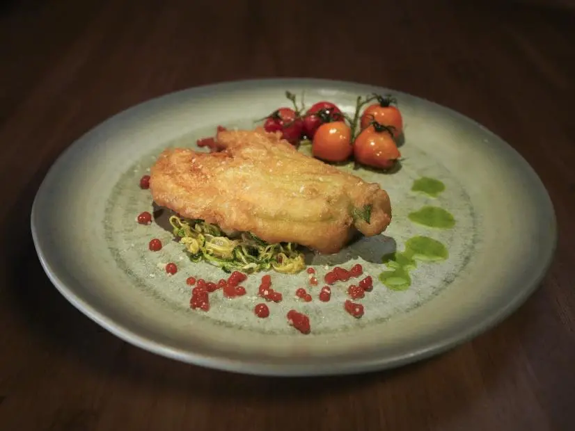 Food beauty shot of Cari Westerman's appetizer: zucchini blossoms with zucchini & onion noodles and tomato caviar on Worst Cooks in America S29.