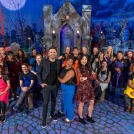 Host Jonathan Bennett and Judges Shinmin Li and Aarti Sequeira and all cast portrait, as seen on Halloween Wars, Season 15.