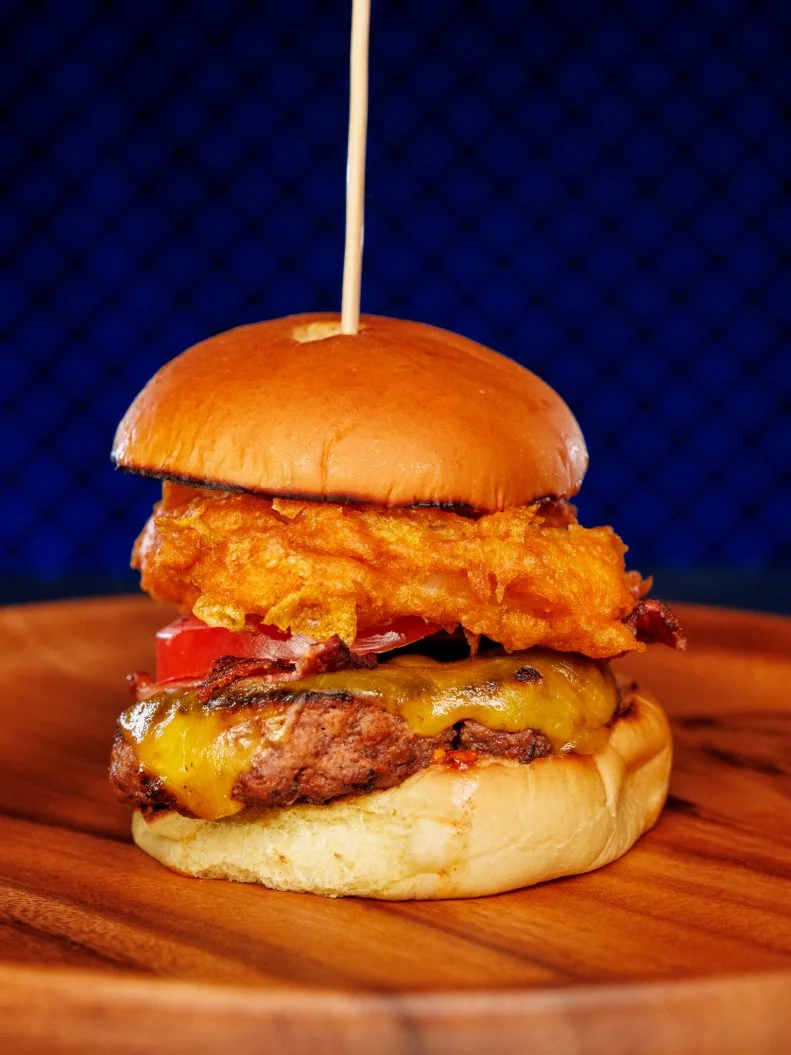 Contestant Tommy Jobst beauty of dish - Classic burger with corn flake fried onion ring, toasted bun and juicy tomato, as seen on Chef Grudge Match, Season 1.