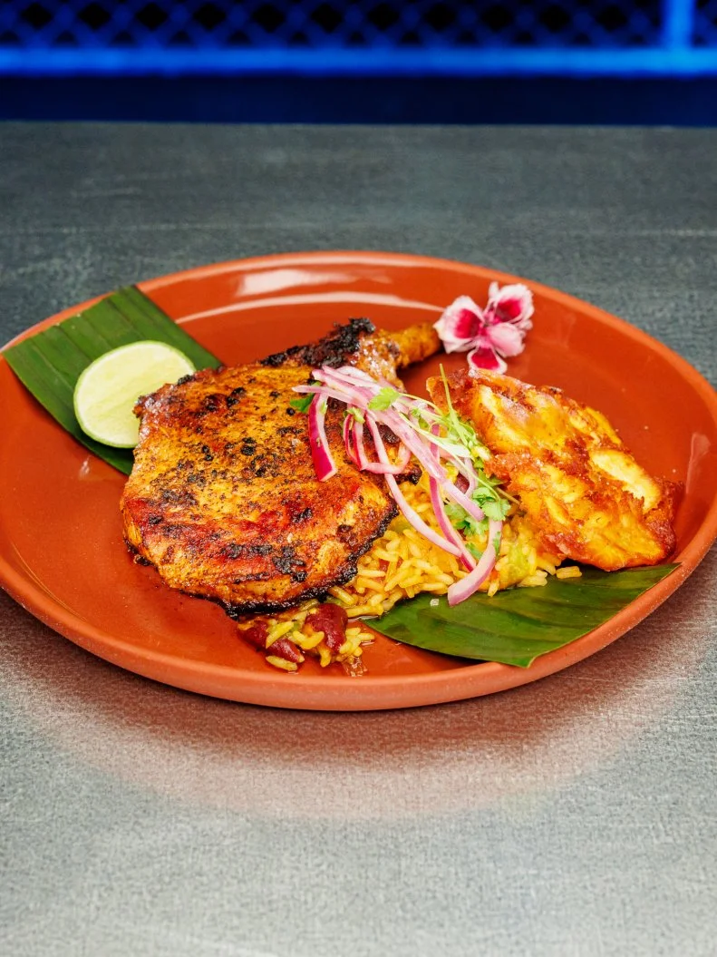 Contestant Mika Leon beauty of dish - Mojo marinated fried pork chops, achiote rice, with tostones and red onion and herb salad, as seen on Chef Grudge Match, Season 1.